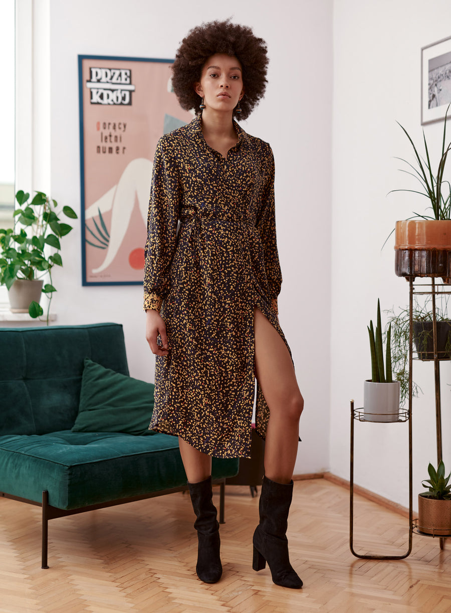 Yellow balck spaltter print shirt dress with contrast cuffs worn by a model. Styled with boots. 